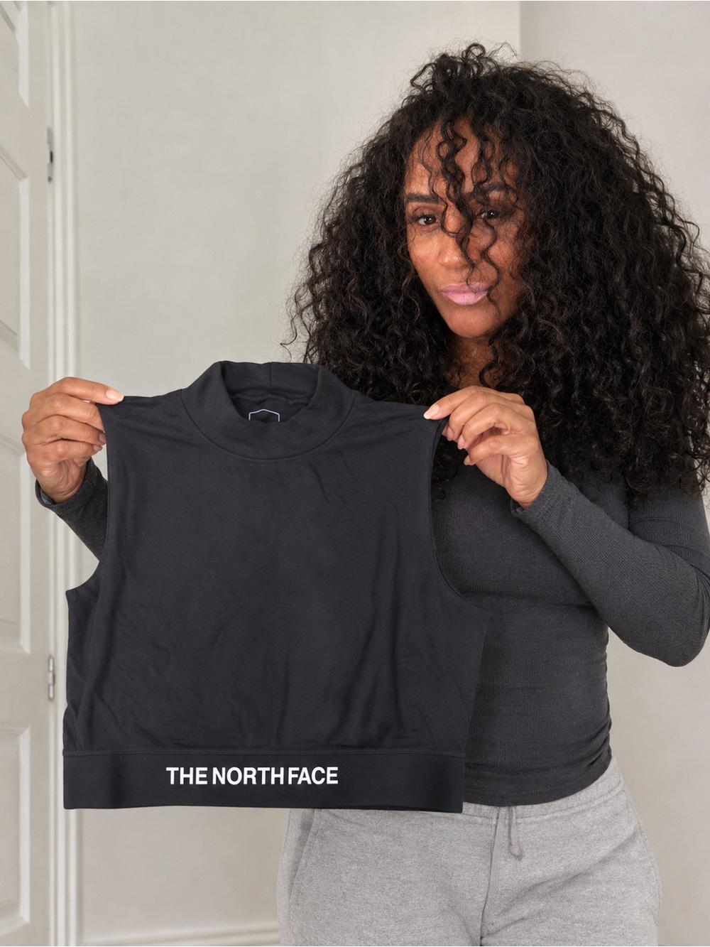 The North Face Black Sleeveless Mock Neck Crop Tank with Branded Hem